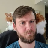 Nice looking bearded man with his cat